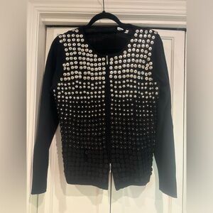 Long sleeve black wool sweater with metal studs. Zip up front from top & bottom.